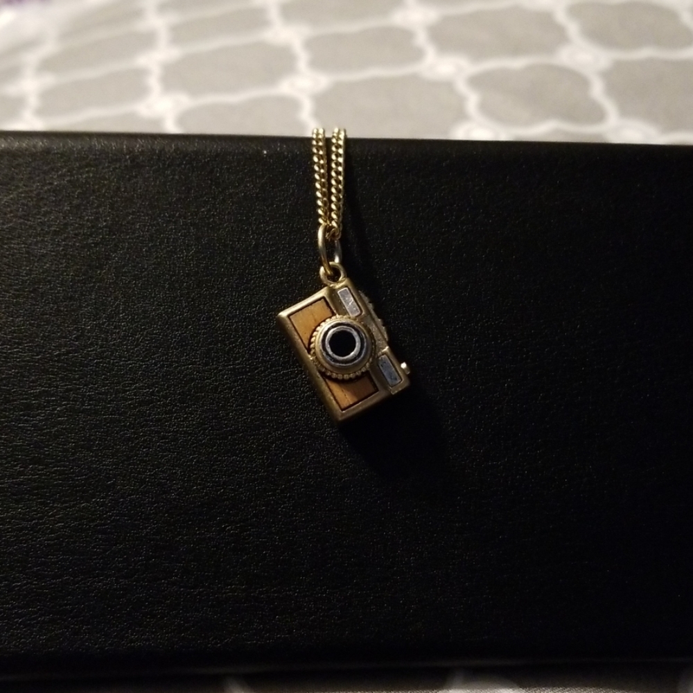 Brass camera charm and chain.